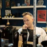 Adam's reflection in a mirror, barber tools in foreground