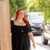 Sarah smiling and walking down the street