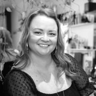 Sarah Bartels headshot outside of the shop